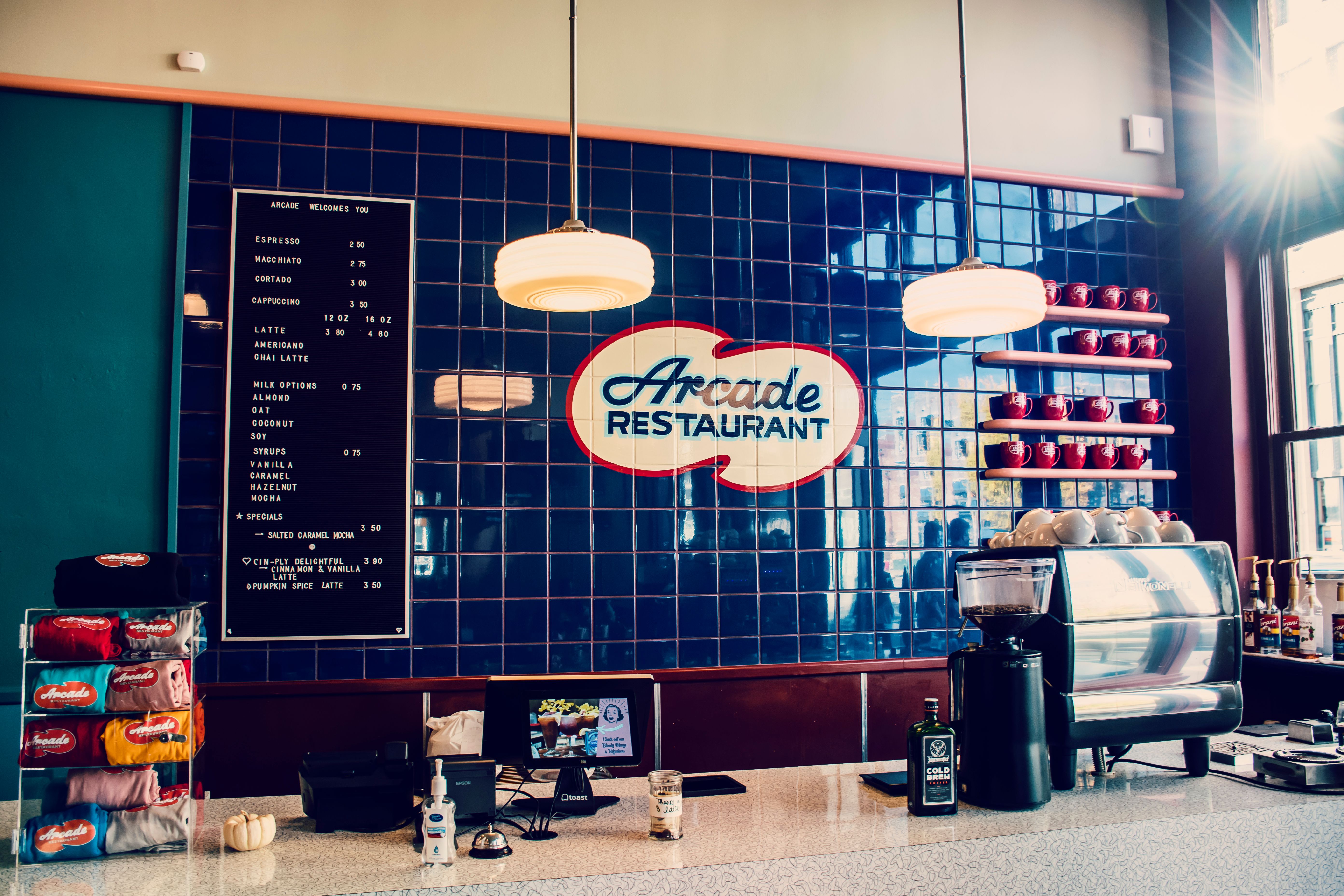 A cozy modern restaurant interior featuring a visible menu board and service counter.